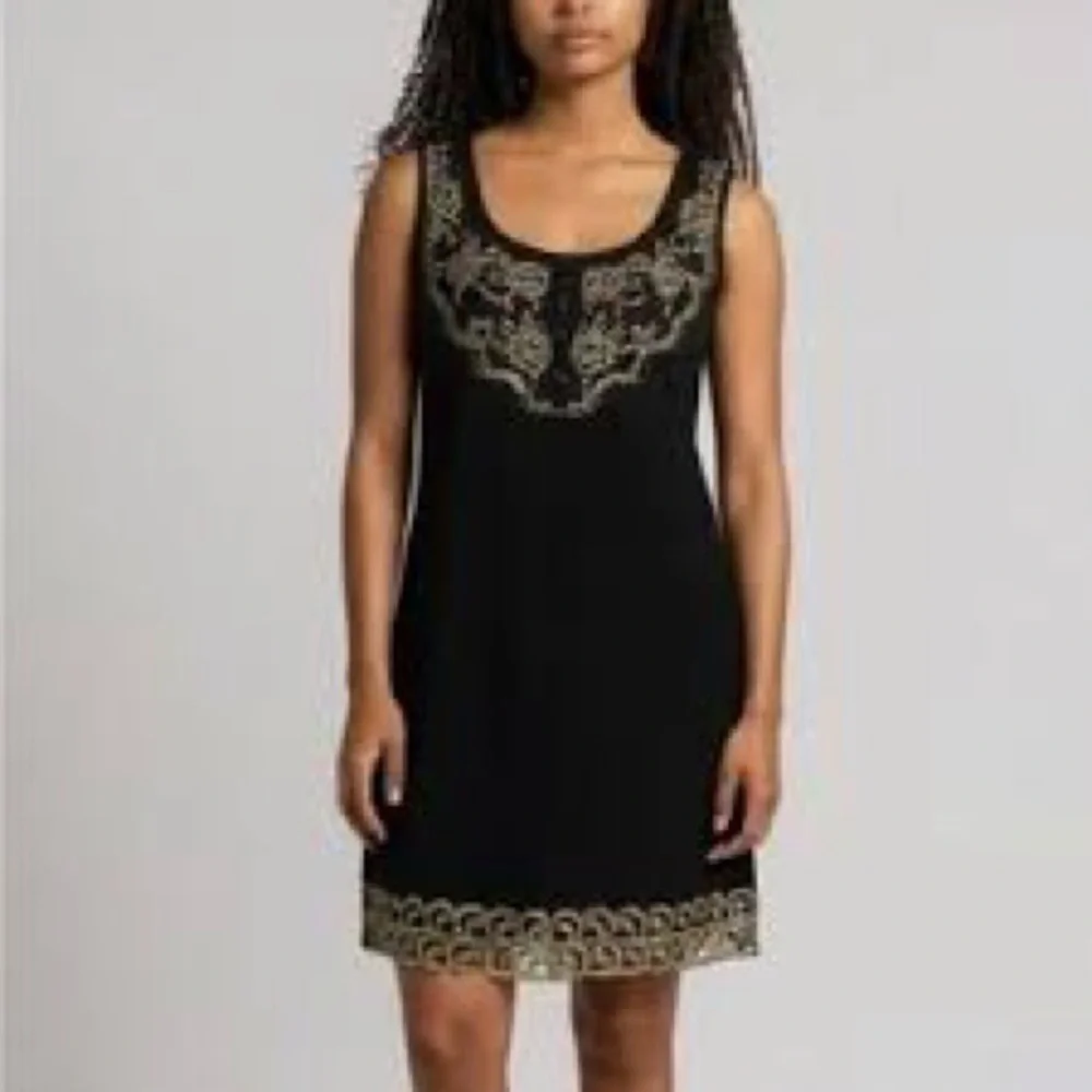 Free People sleeveless black dress with gold metallic embroidery.